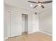 Clean bedroom with closet with sliding doors and wood-look floors at 2331 W Hartford Ave, Phoenix, AZ 85023