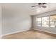 Bedroom featuring new floors, paint, a ceiling fan, and lots of natural light at 2331 W Hartford Ave, Phoenix, AZ 85023