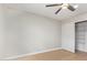 Neutral bedroom with closet with sliding doors and wood-look floors at 2331 W Hartford Ave, Phoenix, AZ 85023