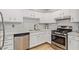 Well-lit kitchen boasts stainless steel appliances, light countertops and white cabinetry at 2331 W Hartford Ave, Phoenix, AZ 85023