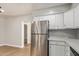Bright kitchen featuring stainless steel appliances, light countertops and white cabinets at 2331 W Hartford Ave, Phoenix, AZ 85023