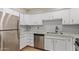 Modern kitchen with stainless steel appliances and white cabinets providing ample storage at 2331 W Hartford Ave, Phoenix, AZ 85023