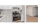 Bright kitchen featuring stainless steel appliances, white cabinets, and light countertops at 2331 W Hartford Ave, Phoenix, AZ 85023