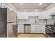 Stylish kitchen with stainless steel appliances and white cabinets providing a modern look at 2331 W Hartford Ave, Phoenix, AZ 85023