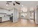 Open living room and kitchen featuring new floors, paint, and stainless steel appliances at 2331 W Hartford Ave, Phoenix, AZ 85023