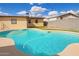 Backyard pool with artificial turf and stone at 2331 W Hartford Ave, Phoenix, AZ 85023