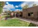 Lush backyard with a covered patio, barbecue area, picnic table, and basketball hoop at 23405 N 84Th St, Scottsdale, AZ 85255