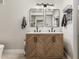 Bathroom featuring a double vanity with chevron cabinets, dual sinks, and sleek fixtures at 23405 N 84Th St, Scottsdale, AZ 85255