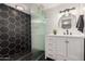 Stylish bathroom featuring black and white hexagon tile shower, vanity, and vessel sink at 23405 N 84Th St, Scottsdale, AZ 85255