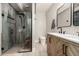 Bathroom showcasing chevron wood vanity, tiled shower, and modern fixtures for a spa-like experience at 23405 N 84Th St, Scottsdale, AZ 85255