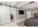 Open bedroom view featuring a white sliding barn door leading to the Primary bathroom at 23405 N 84Th St, Scottsdale, AZ 85255