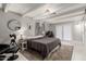 Spacious bedroom with beamed ceilings, a round mirror, and a sliding glass door to the outside at 23405 N 84Th St, Scottsdale, AZ 85255