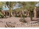 Desert landscaping surrounds this charming home with unique architectural details at 23405 N 84Th St, Scottsdale, AZ 85255