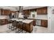 A gourmet kitchen with stainless steel appliances, an island, and dark wood cabinetry at 23405 N 84Th St, Scottsdale, AZ 85255