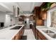 Spacious kitchen with stainless steel appliances, light countertops, and dark wood cabinets at 23405 N 84Th St, Scottsdale, AZ 85255