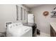 Functional laundry room with modern washer and dryer, complemented by neutral walls at 23405 N 84Th St, Scottsdale, AZ 85255