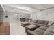 An inviting living room with a sectional sofa, tile floors, and neutral walls at 23405 N 84Th St, Scottsdale, AZ 85255