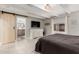 Well-lit bedroom boasting a decorative barn door, large bed, and stylish wood-beam ceiling at 23405 N 84Th St, Scottsdale, AZ 85255