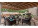 Relaxing covered patio with comfortable seating, outdoor kitchen area, and landscaped surroundings at 23405 N 84Th St, Scottsdale, AZ 85255