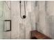 Close up on the shower featuring gray tile walls and a dark wood bench for a spa-like experience at 23405 N 84Th St, Scottsdale, AZ 85255