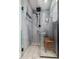 Modern shower with blue tiling, a built-in niche, and a wooden bench for a spa-like experience at 23405 N 84Th St, Scottsdale, AZ 85255