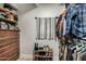 Organized walk-in closet with built in shelving and shoe rack maximizes storage space at 23405 N 84Th St, Scottsdale, AZ 85255