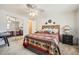 Comfortable bedroom with ceiling fan, carpet flooring, and a mirrored closet at 2400 E Baseline Ave # 94, Apache Junction, AZ 85119