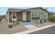 Charming single-story home with desert landscaping and a covered patio at 2400 E Baseline Ave # 94, Apache Junction, AZ 85119