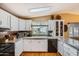 Well-lit kitchen featuring white cabinets, granite countertops, and hardwood flooring at 2400 E Baseline Ave # 94, Apache Junction, AZ 85119