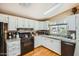 Efficient kitchen featuring white cabinetry, granite countertops, and appliances at 2400 E Baseline Ave # 94, Apache Junction, AZ 85119