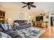 Comfortable living room featuring hardwood floors, TV, and ceiling fan at 2400 E Baseline Ave # 94, Apache Junction, AZ 85119