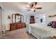 Serene main bedroom featuring a ceiling fan, a large dresser and ensuite bathroom at 2400 E Baseline Ave # 94, Apache Junction, AZ 85119