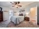 Serene main bedroom featuring a ceiling fan, a large dresser and ensuite bathroom at 2400 E Baseline Ave # 94, Apache Junction, AZ 85119