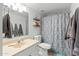 Neat bathroom includes a vanity, updated fixtures, and shower with decorative curtain at 2434 W Eugie Ave, Phoenix, AZ 85029