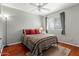Cozy bedroom with hardwood floors, ceiling fan, and natural light creating a warm and inviting atmosphere at 2434 W Eugie Ave, Phoenix, AZ 85029