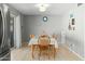 Dining area with a table for six adjacent to the kitchen with sliding glass door at 2434 W Eugie Ave, Phoenix, AZ 85029
