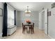 Inviting dining room with chandelier, storage bench, and natural light at 2434 W Eugie Ave, Phoenix, AZ 85029