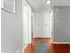 Bright hallway features hardwood floors, ample storage, and neutral paint, creating a clean and welcoming entrance at 2434 W Eugie Ave, Phoenix, AZ 85029
