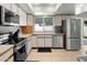 Well lit kitchen with tile flooring, stainless steel appliances and white cabinets at 2434 W Eugie Ave, Phoenix, AZ 85029