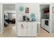 Kitchen cart with coffee bar setup, decorative art, and view to living and laundry room at 2434 W Eugie Ave, Phoenix, AZ 85029