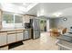 The kitchen flows into the dining area, featuring stainless steel appliances and tile flooring at 2434 W Eugie Ave, Phoenix, AZ 85029