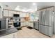 Bright kitchen featuring stainless steel appliances, tile flooring, and ample cabinet space at 2434 W Eugie Ave, Phoenix, AZ 85029