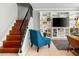 Welcoming living room with a staircase, tile flooring, and neutral decor at 2434 W Eugie Ave, Phoenix, AZ 85029