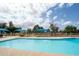 Community pool area featuring sun shades, seating, and well-maintained surroundings, perfect for relaxing outdoors at 2434 W Eugie Ave, Phoenix, AZ 85029