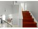 Interior staircase with wooden steps and neutral walls, offering a glimpse into the dining area at 2434 W Eugie Ave, Phoenix, AZ 85029