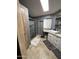 Updated bathroom featuring a tiled walk-in shower and granite counters with modern fixtures at 2661 N Wright Way, Mesa, AZ 85215