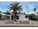 Charming single-story home featuring a desert-landscaped front yard, palm tree, and a covered carport at 2661 N Wright Way, Mesa, AZ 85215