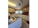 Functional kitchen featuring an island cooktop, ample cabinet space, and neutral countertops at 2661 N Wright Way, Mesa, AZ 85215