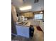 Efficient kitchen layout with an island cooktop, white cabinetry, and plentiful countertop space at 2661 N Wright Way, Mesa, AZ 85215