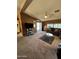 Comfortable living room with neutral carpet, television, and bright natural light at 2661 N Wright Way, Mesa, AZ 85215